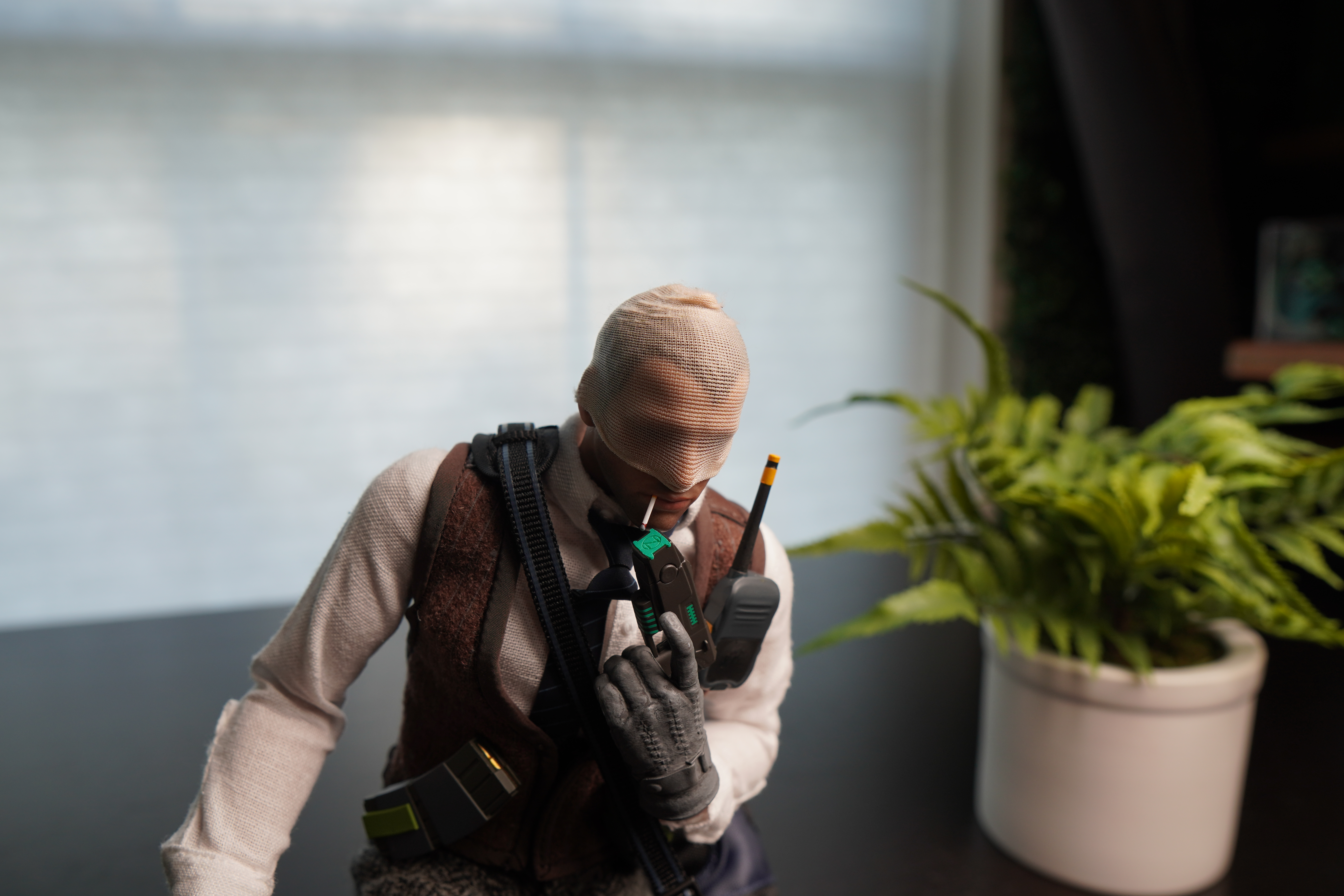 Agent number K figurine with smoking a cigarette with plant in background