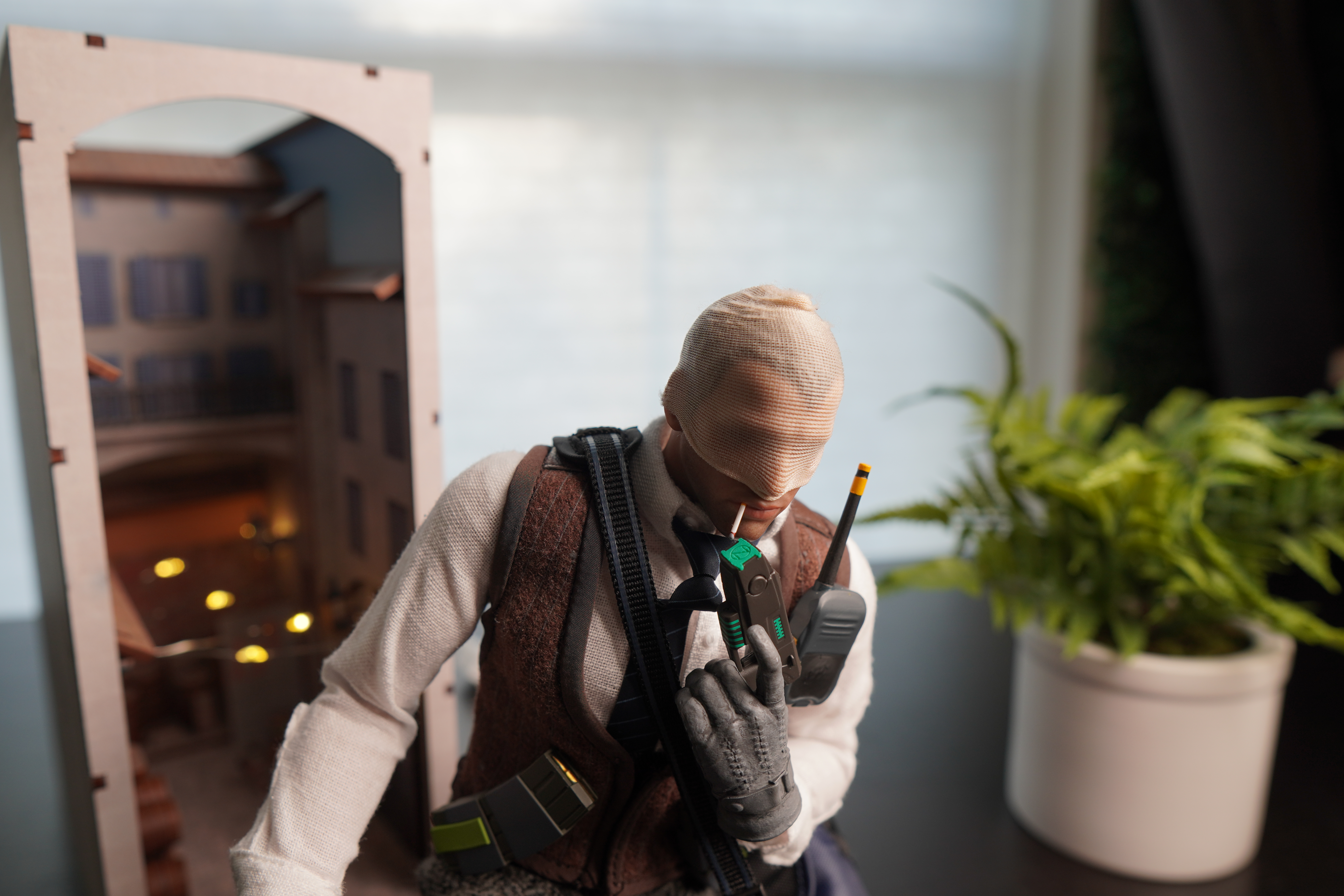 Agent number K figurine with smoking a cigarette with inferno bookend and plant in background
