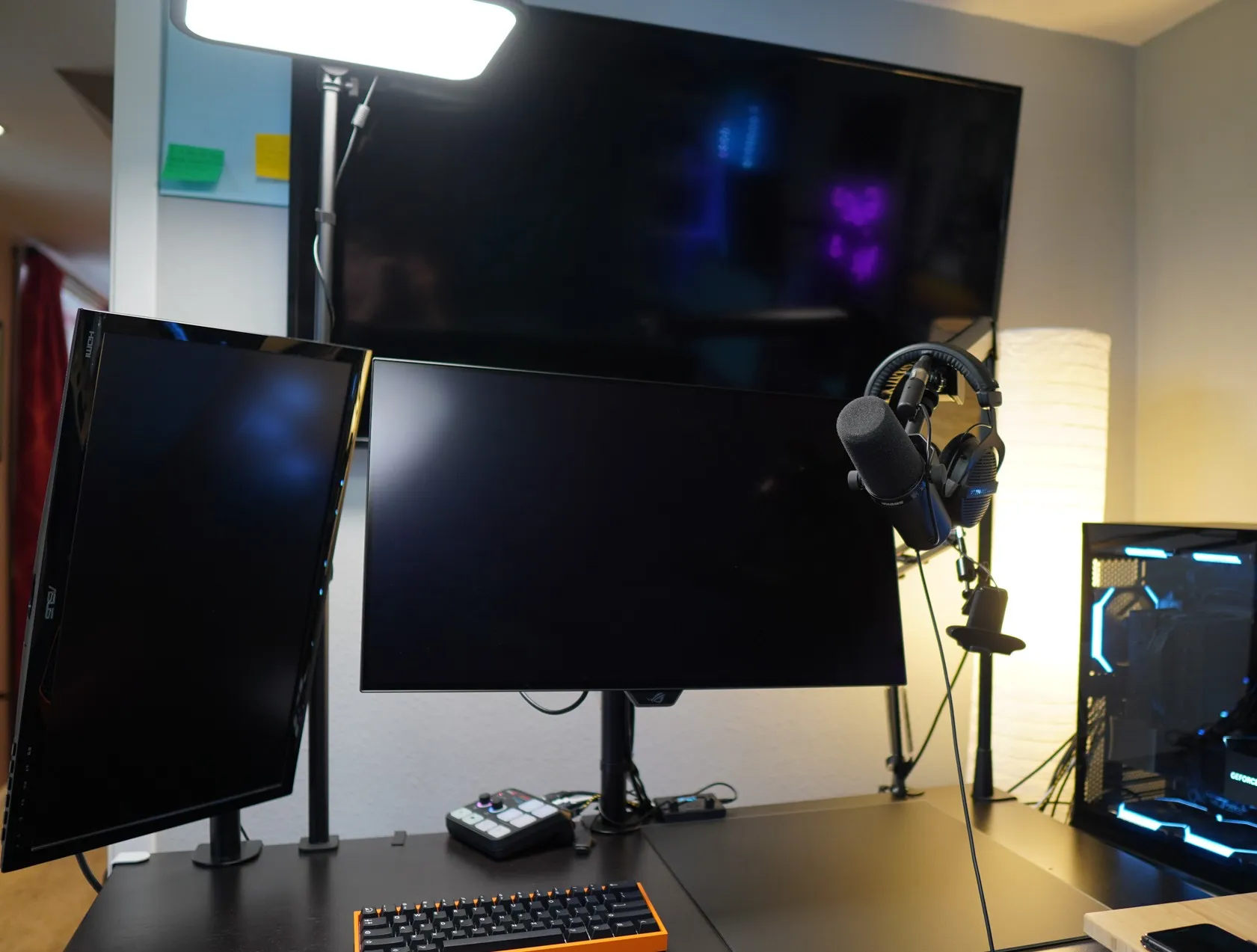 Gaming setup with 2 monitors tv wooting keyboard pc in background